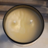 top view of beeswax candle in black travel tin