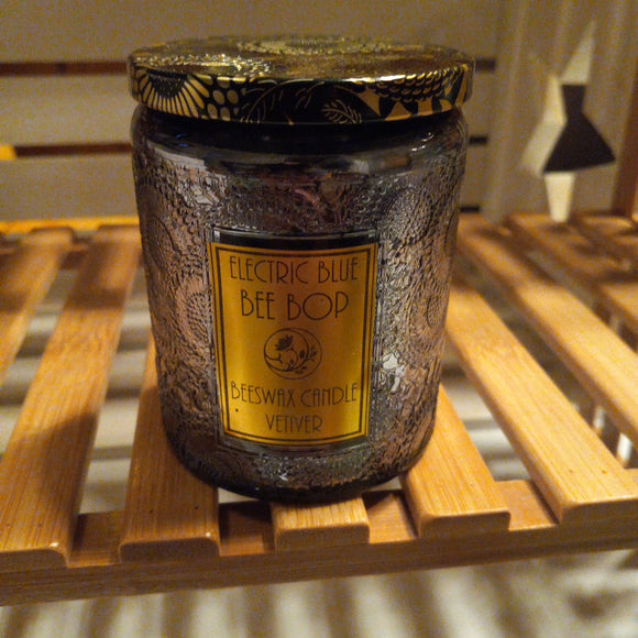 beeswax candle in dark gray embossed glass container vetiver scented