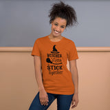 witches gotta stick together black lettering on orange tshirt with witch hat and broomstick