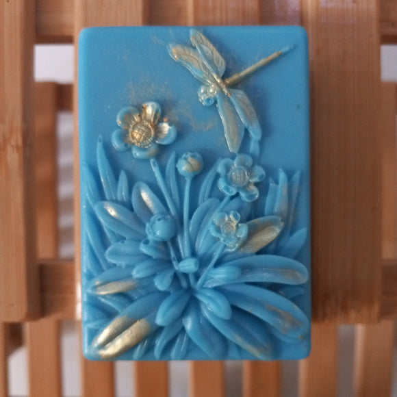 blue dragonfly goats milk soap scened with plumeria and brushed with gold mica