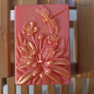 hot pink light red dragonfly goats milk soap scented with red poppy fragrance and brushed with gold mica