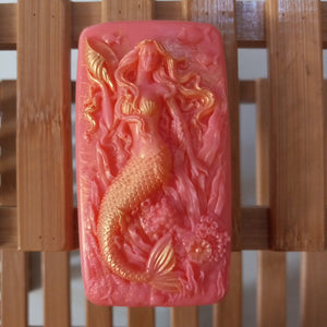 light red hot pink mermaid and seashells goats milk soap scented with a red poppy fragrance and brushed with gold mica