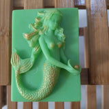 green mermaid holding a pearl, goat milk soap scented with cucumber melon and brushed with gold mica