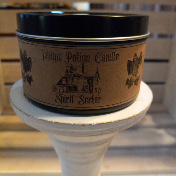 spirit seeker halloween beeswax candle in black travel tin and craft label with ghosts and haunted houses