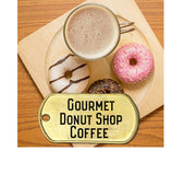 Gourmet donut shop coffee pictured in a ccup with savory donuts