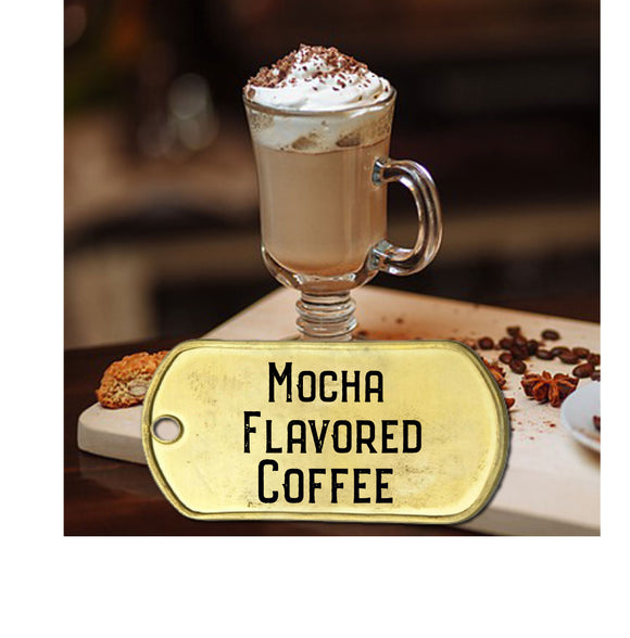 Mocha flavored coffee in a glass mug topped with whip cream and chocolate sprinkles