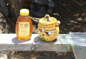 Sage honey in 1 pound jar next to honey pot