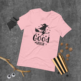 good witch pink tshirt with black lettering and a witch riding a broom