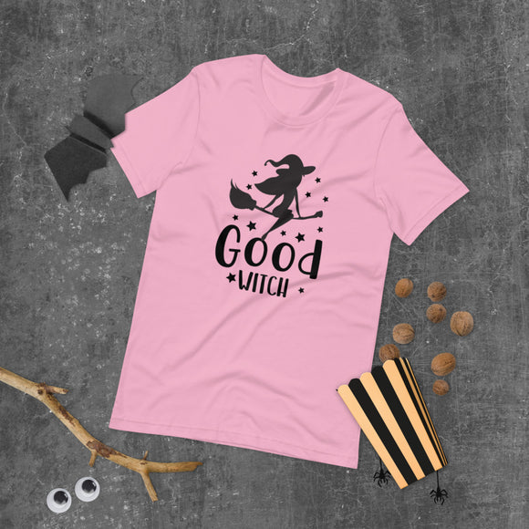 good witch pink tshirt with black lettering and a witch riding a broom
