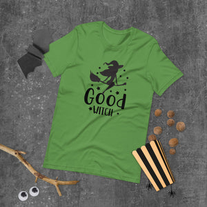 good witch pink tshirt with black lettering and a witch riding a broom