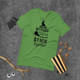 witches gotta stick together black lettering on green tshirt with witch hat and broomstick